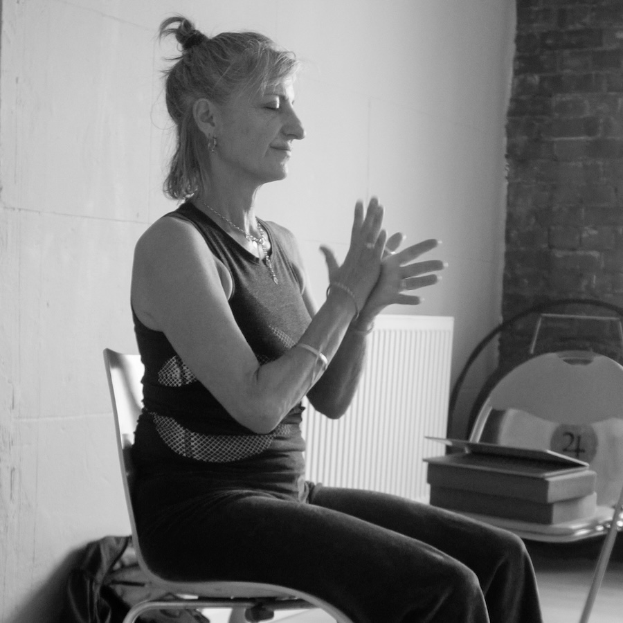 Dinal Cohen demonstrating a sequnce during her Chair Yoga Tecaher training