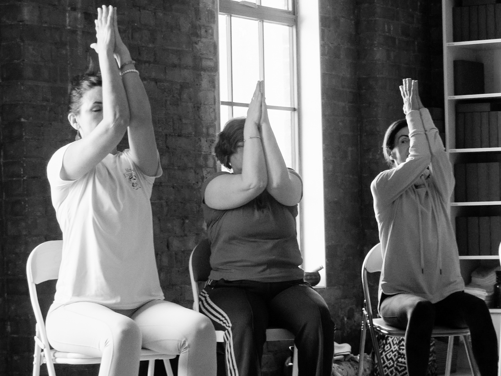 Trainee teachers practicing chair with Dina Cohen at the Shala London