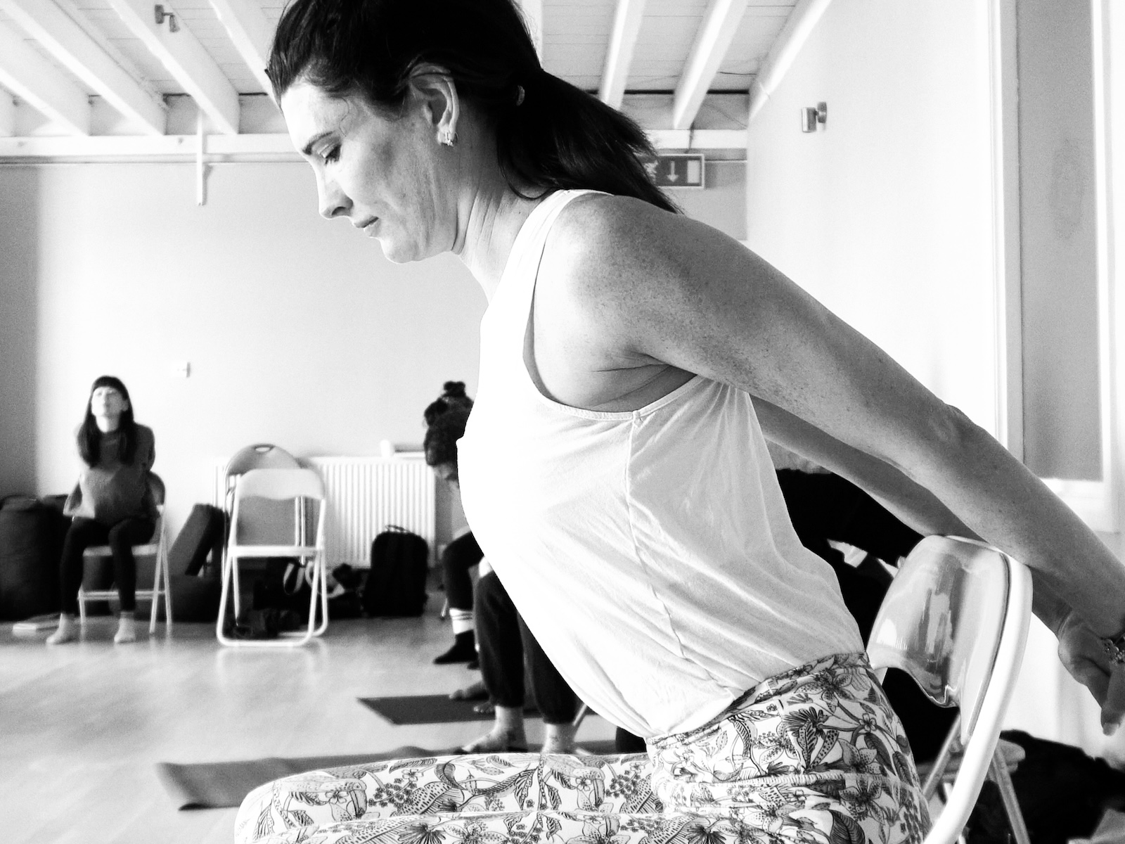 Student practicing chair yoga on a yoga teacher training weekend at the Shala in London