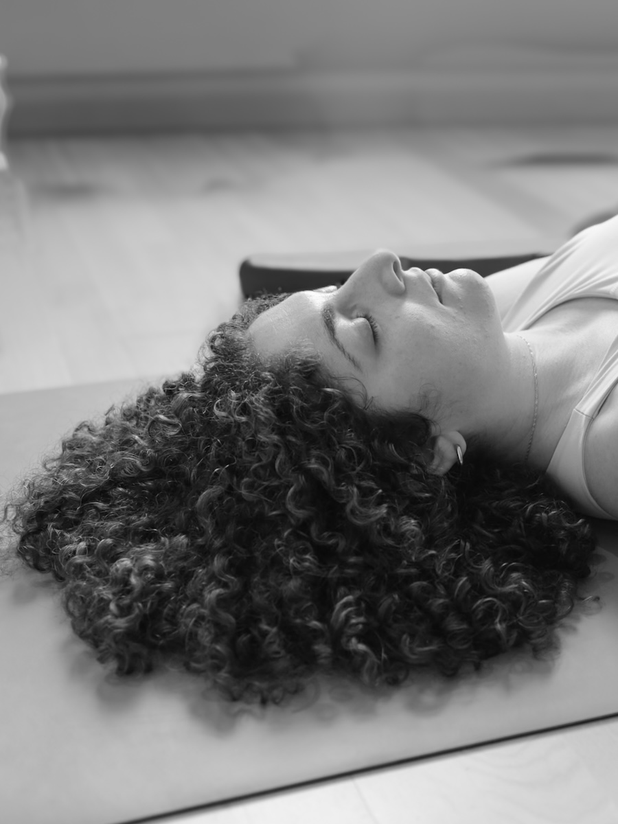 Student in deep yoga nidra relaxation on Elemental Yoga Nidra Teacher Training in London with Emma Landolt