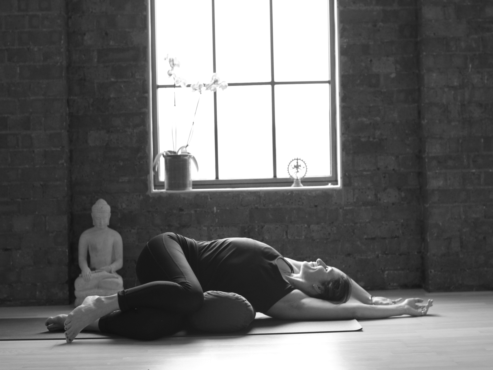 Ellie Grace in a a restorative yin posture during her trauma Informed Yoga Teacher Training
