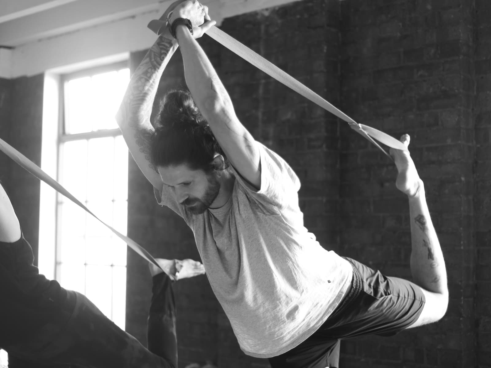 Student working with a strap in Dancer Posture on 300-hour yoga teacher training