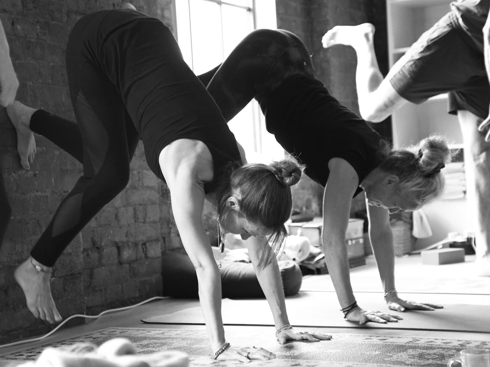 Students working to break down handstands using the wall on 300-hour teacher training