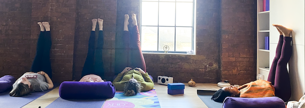 Trainees in legs up the wall during 300-hour yoga teacher training