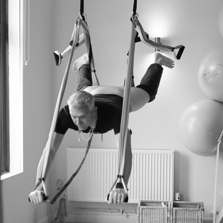 Gingi Lee teaching an Aerial Yoga class