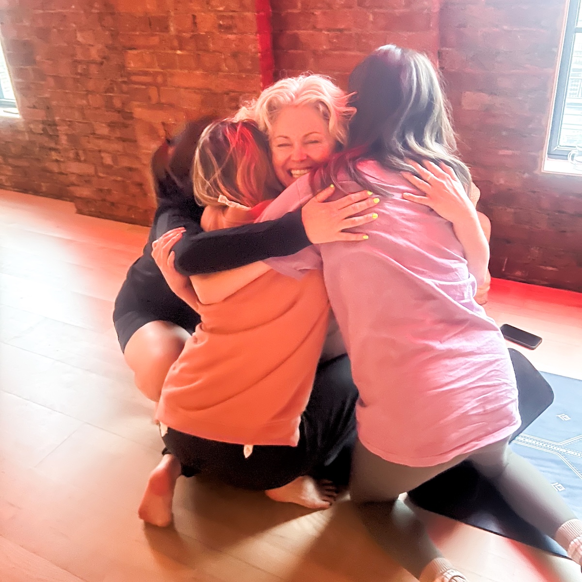 Group hug after a trainee finishes her 200-hour teaching assessment