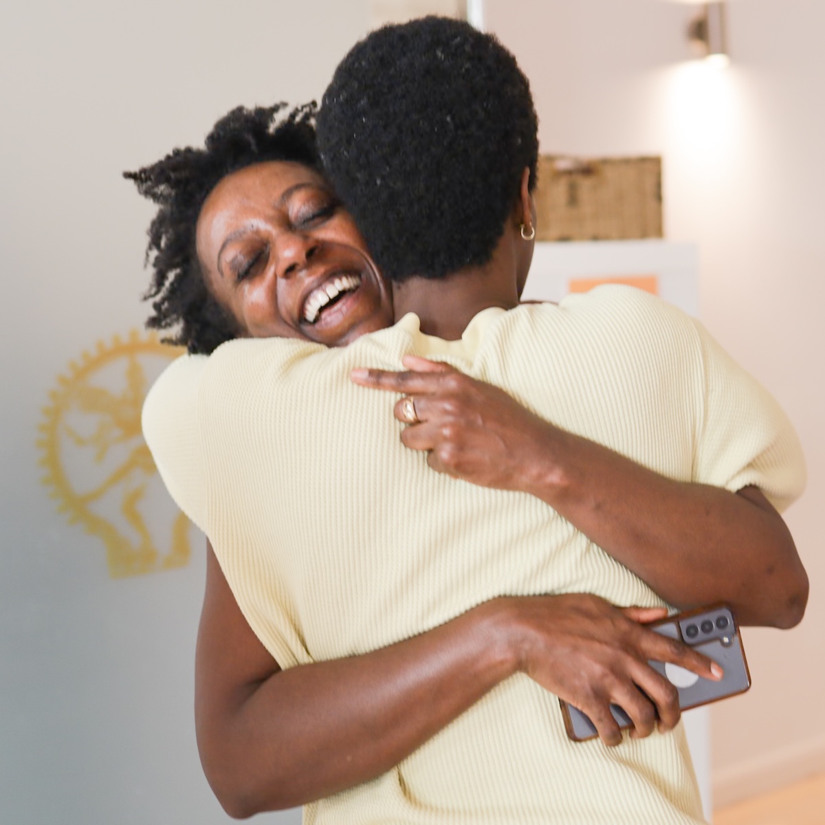 Two students hugging after a final assessment on 200-hour yoga teacher training