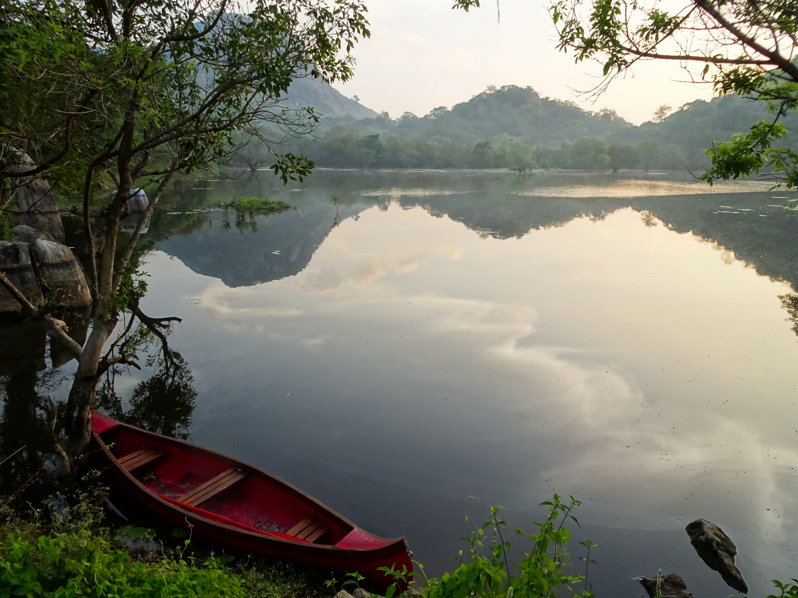 Lake and boat at dawn Ulpotha Retreat, Sri Lanka