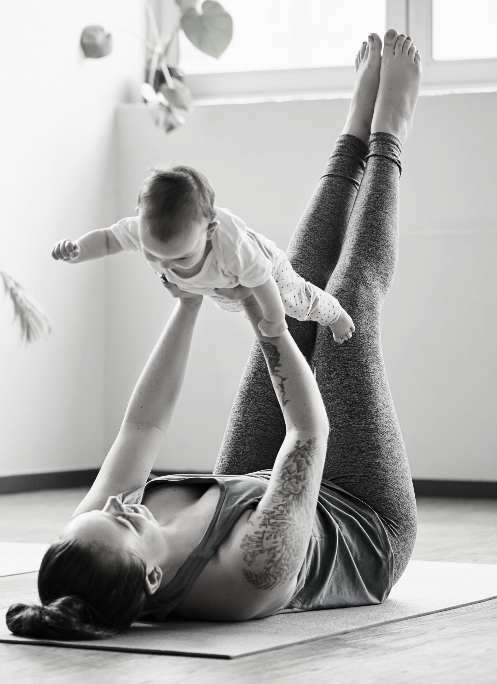 Mum and baby doing post-natal yoga