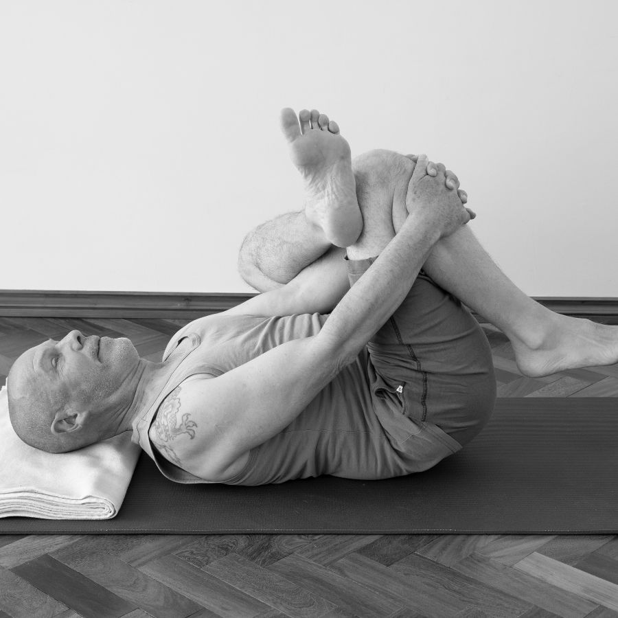 Norman Blair in a Reclined Pigeon Pose for his Yin Yoga Course at the Shala