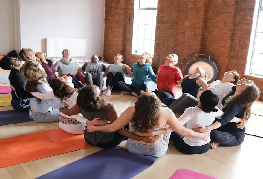 200-hour students in an interlinked group circle at the Shala