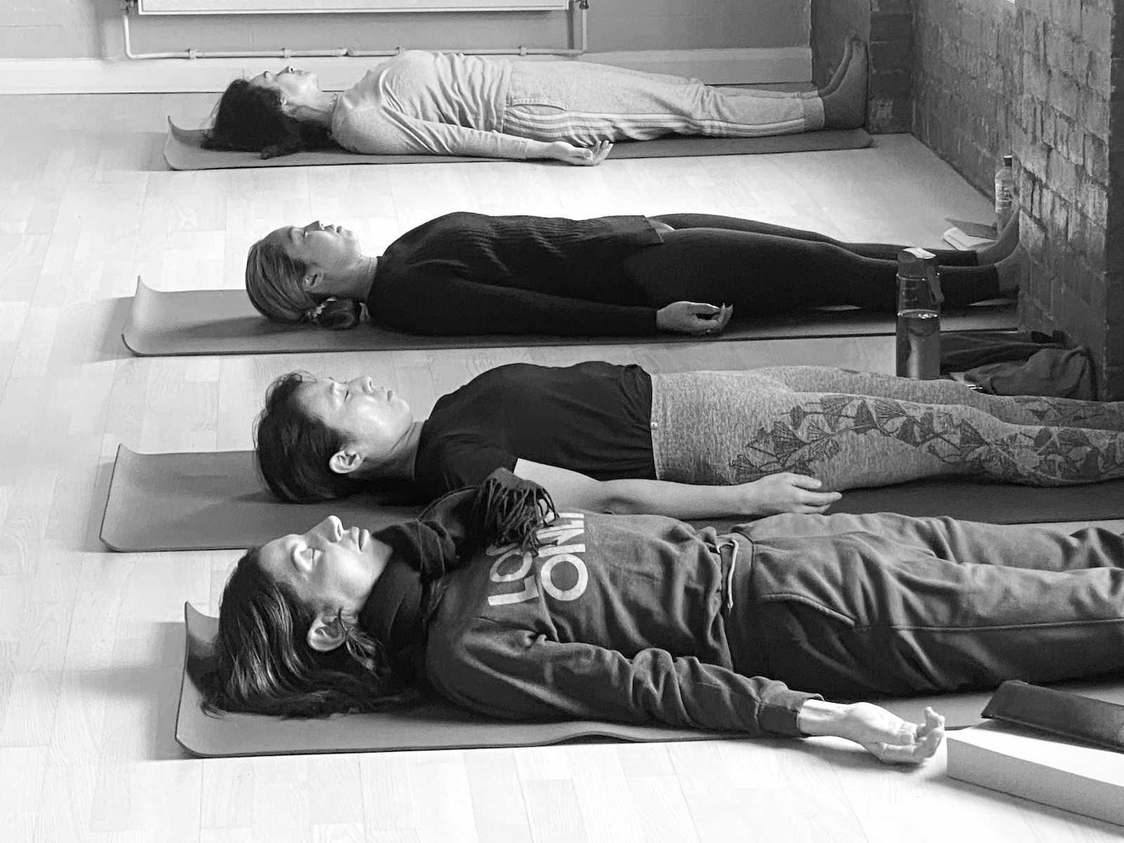 Students practicing yoga nidra on teacher training course