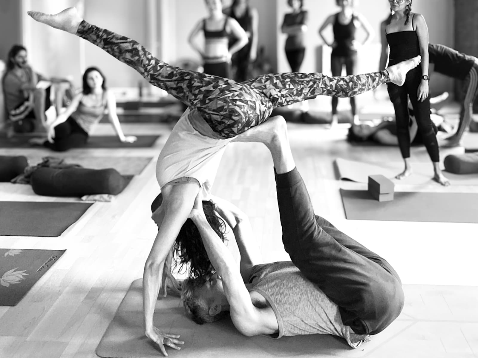 Charli Van Ness and Gingi Lee demonstrating supported handstand partner work
