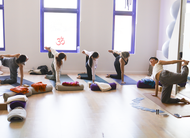 Student leading a group during her yoga teacher training assessment