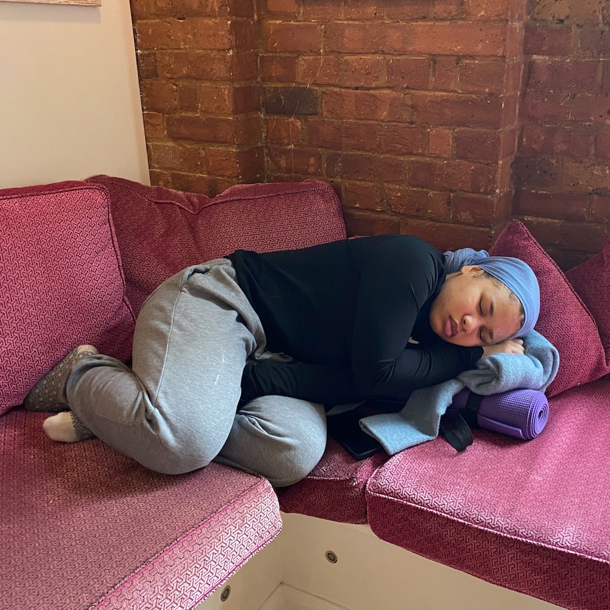 Teacher tainee taking a snooze in the lounge area at the Shala during a training weekend