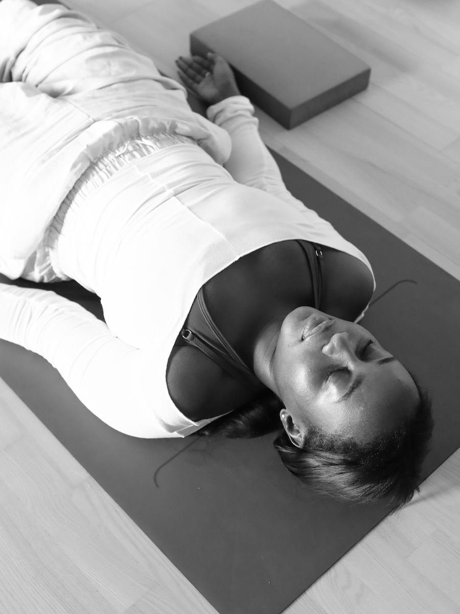 Student in deep relaxation at yoga nidra course with Melanie Cooper and Jennie Wadsten Sharma, London UK
