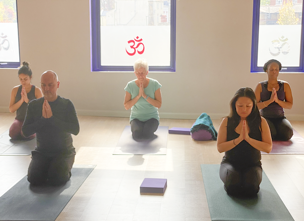 Students at the end of a class during yoga teacher training