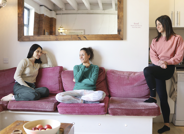 Yoga teacher trainees chatting in the lounge on a break